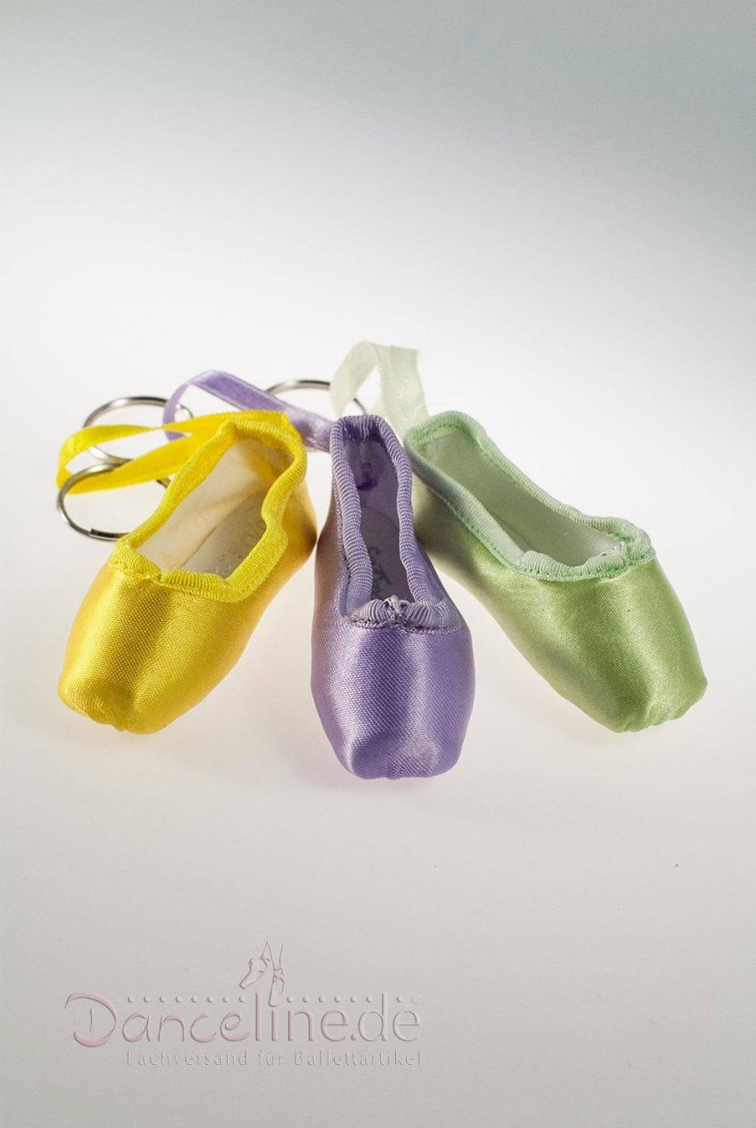 Das Bild zeigt drei Mini-Spitzenschuh-Anhänger SoDanca KCE01 Minipoint-Schlüsselanhänger mit daran befestigten Miniatur-Ballettschuhen. Die aus Satinstoff gefertigten Schuhe sind in drei Farben erhältlich: Gelb, Lila und Grün. Sie sind nebeneinander vor einem schlichten weißen Hintergrund angeordnet.